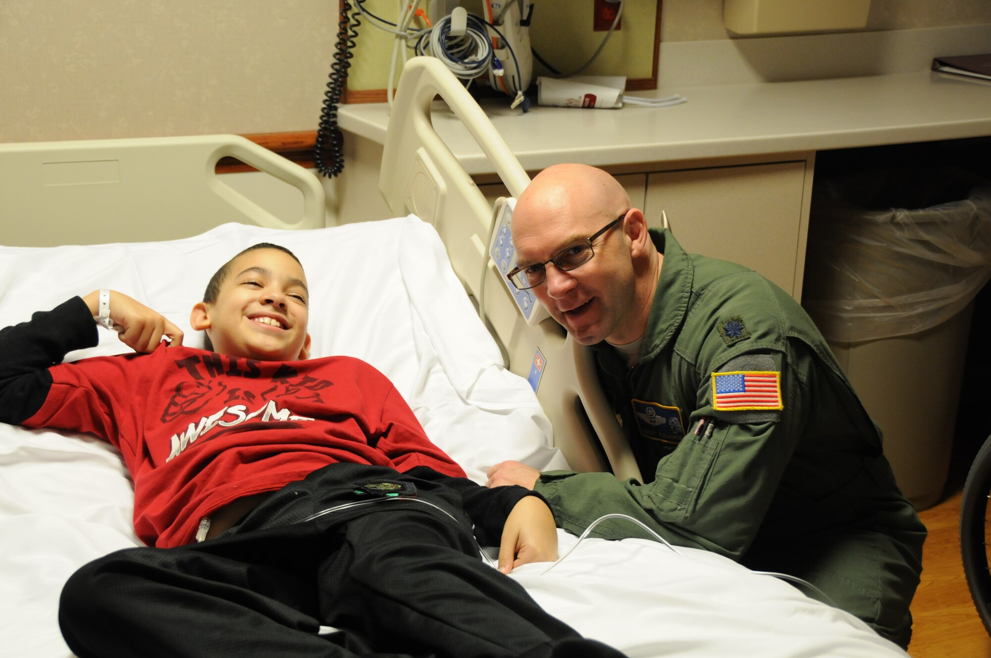 YOUNGSTOWN AIR RESERVE STATION, Ohio—Lieutenant Colonel John “Chinky” Kochansky, assistant deputy officer of the 757th Airlift Squadron, talks to 11-year-old Micah while visiting the Boardman campus of Akron Children’s Hospital, Dec. 16. Several YARS members visited the hospital to spread holiday cheer, passing out toys collected during the YARS-based Marine Corps Reserve Detachment-3 Maintenance Company’s Toys for Tots campaign, along with Air Force promotional items and wing patches. This year’s hospital visit marked the fourth consecutive December trip. (U.S. Air Force photo/Eric M. White)