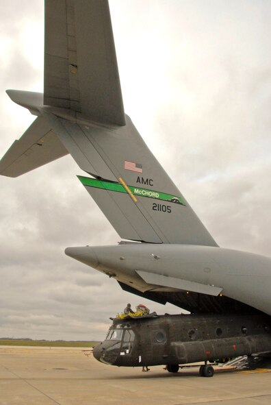 An Illinois Army National Guard CH-47 Chinook exits an Air Force C-17 Globemaster III at the Peoria Army Aviation Support Facility, Peoria, Ill., Nov. 26, 2013. The aircraft transported the helicopter back to the 2nd Battalion, 238th General Support Aviation Battalion from service in Afghanistan. (U.S. Air National Guard photo by Staff Sgt. Lealan C. Buehrer/Released)