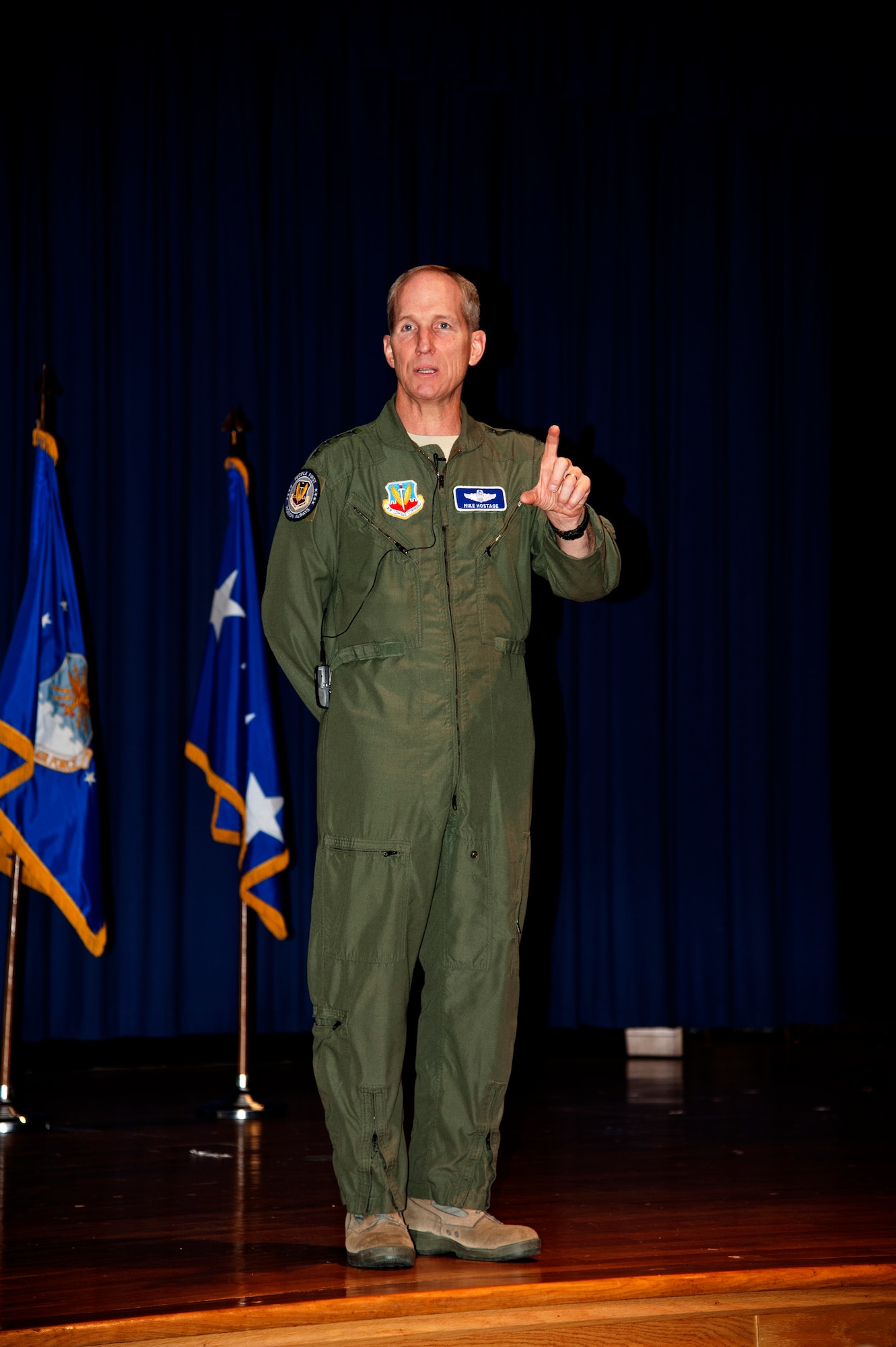 Gen. Mike Hostage, commander of Air Combat Command, addressed Headquarters ACC personnel during three all-calls at Langley Air Force Va., Dec. 12, 2013. Hostage reminded personnel that the Command is in the midst of its Winter Safety Campaign, he challenged everyone to be good wingmen, and get involved when co-workers are seen embarking down an unsafe path, especially over the holidays on travel plans. (U.S. Air Force photo by Staff Sgt. Candice Page/Released) 