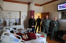 YOUNGSTOWN AIR RESERVE STATION, Ohio—YARS personnel including U.S. Marine Corps Chief Warrant Officer 4 Michael Hudson, Inspector/Instructor of the Detachment-3 Maintenance Company (Det-3); and U.S. Air Force Lieutenant Colonel Christopher Zwetzig, 910th Operations Group standards evaluation navigator; Colonel James Dignan, 910th Airlift Wing Commander; and Lieutenant Colonel John “Chinky” Kochansky, assistant deputy officer of the 757th Airlift Squadron, talk to 18-year-old Katherine while visiting the Boardman campus of Akron Children’s Hospital, Dec. 16. Several YARS members visited the hospital to spread holiday cheer, passing out toys collected during Det.-3’s Toys for Tots campaign, along with Air Force promotional items and wing patches. This year’s hospital visit marked the fourth consecutive December trip. (U.S. Air Force photo/Eric M. White)