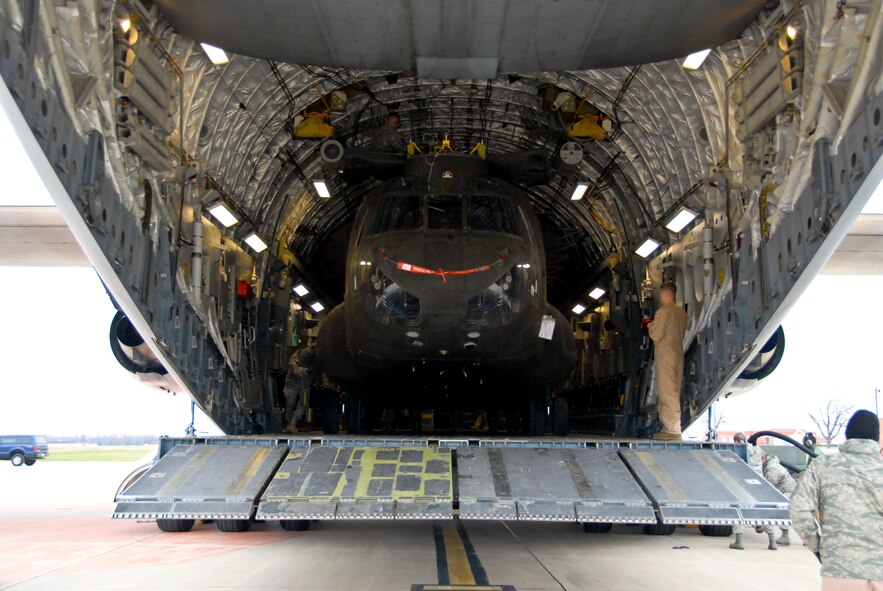 An Illinois Army National Guard CH-47 Chinook exits an Air Force C-17 Globemaster III at the Peoria Army Aviation Support Facility, Peoria, Ill., Nov. 26, 2013. The aircraft transported the helicopter back to the 2nd Battalion, 238th General Support Aviation Battalion from service in Afghanistan. (U.S. Air National Guard photo by Staff Sgt. Lealan C. Buehrer/Released)