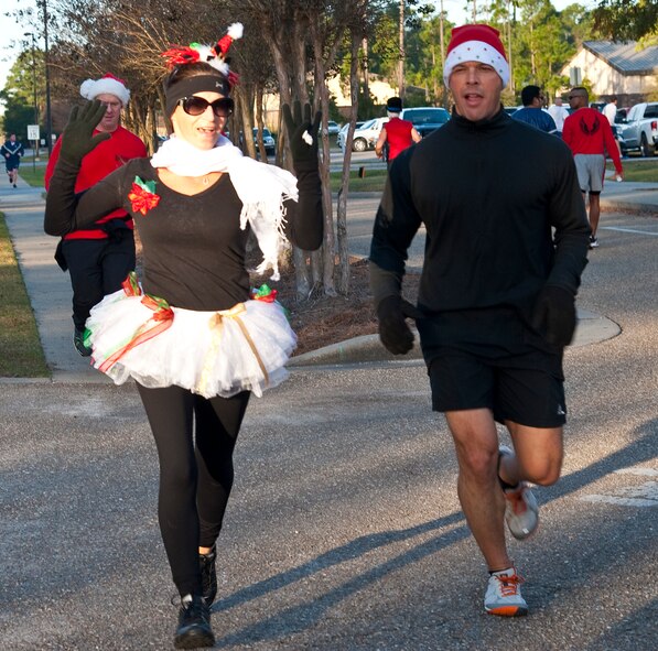 Runners raced during the Jingle Bell 5K at Hurlburt Field, Fla., Dec. 13, 2013. The 1st Special Operations Force Support Squadron hosts monthly themed runs on Hurlburt Field. (U.S. Air Force photo/Senior Airman Michelle Vickers) 