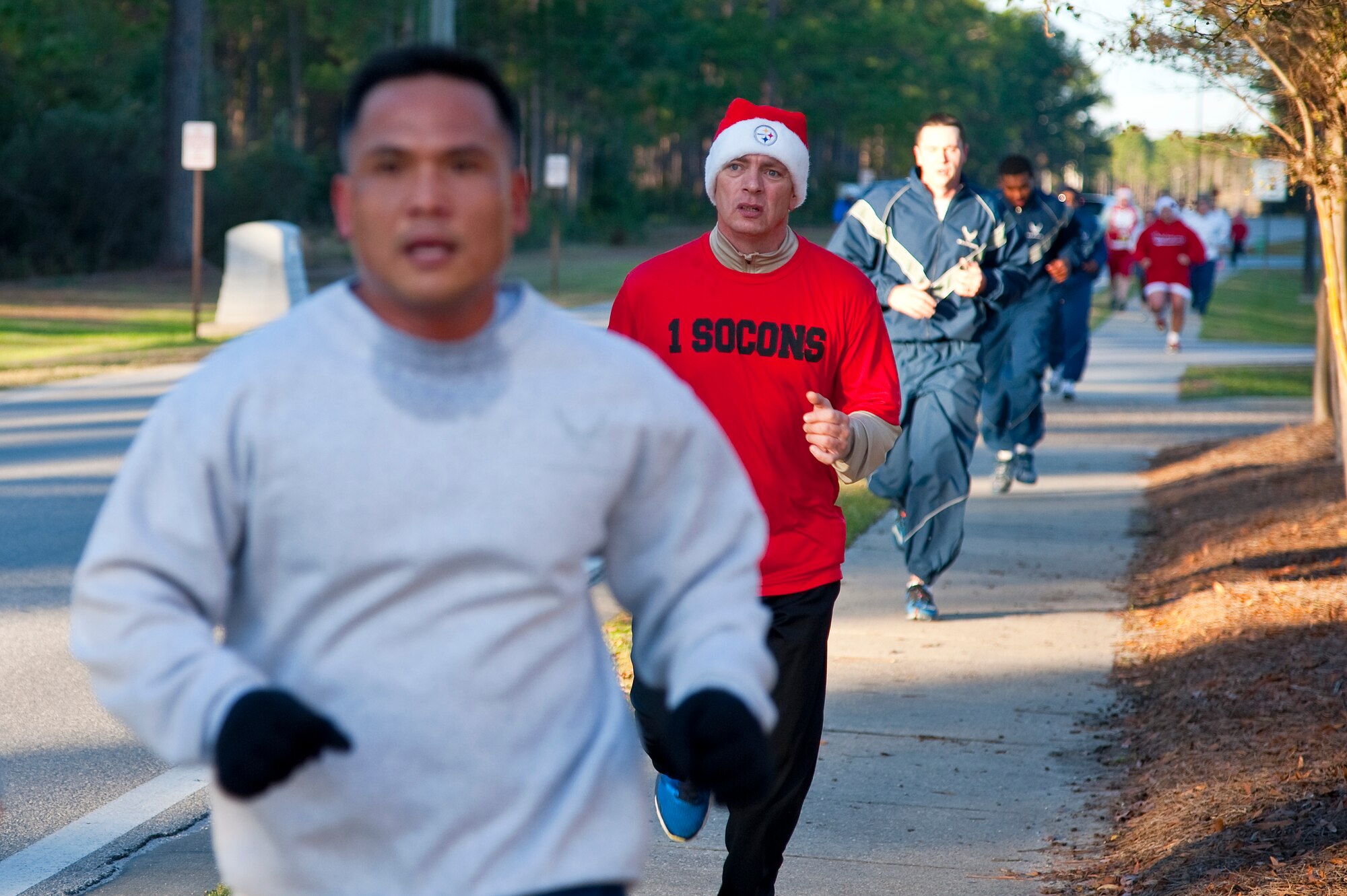 Runners raced during the Jingle Bell 5K at Hurlburt Field, Fla., Dec. 13, 2013. The 1st Special Operations Force Support Squadron hosts monthly themed runs on Hurlburt Field. (U.S. Air Force Photo/Senior Airman Michelle Vickers) 