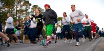 Runners raced during the Jingle Bell 5K at Hurlburt Field, Fla., Dec. 13, 2013. The 1st Special Operations Force Support Squadron hosts monthly themed runs on Hurlburt Field. (U.S. Air Force Photo/Senior Airman Michelle Vickers) 