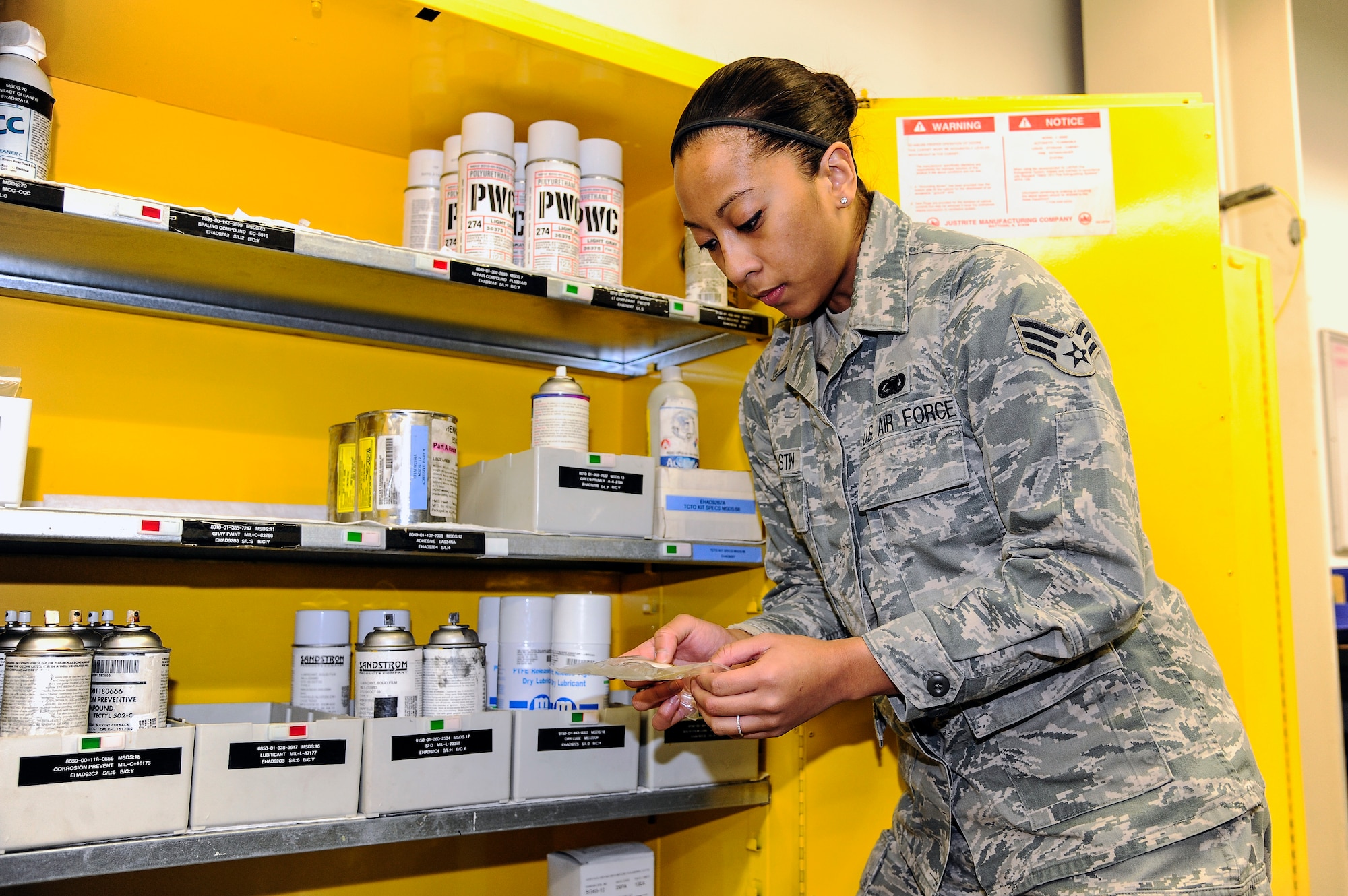 Senior Airman Heidi Agustin, 354th Aircraft Maintenance Squadron combat oriented supply organization technician, inspects an item’s expiration date Dec. 11, 2013, Eielson Air Force Base, Alaska. As a COSO technician, Agustin ensures the accountability of supplies. (U.S. Air Force photo by Senior Airman Zachary Perras/Released)