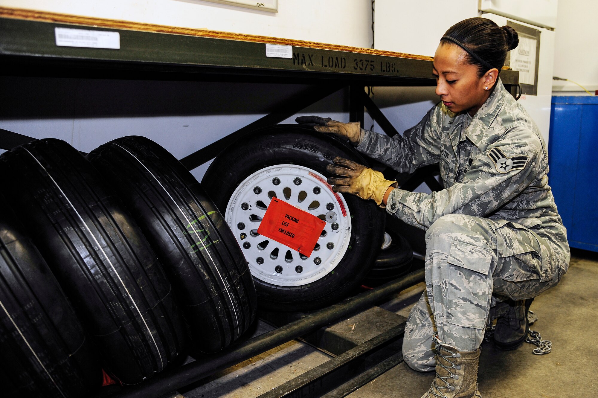 Senior Airman Heidi Agustin, 354th Aircraft Maintenance Squadron combat oriented supply organization technician, prepares an aircraft tire to be checked out to a maintainer Dec. 11, 2013, Eielson Air Force Base, Alaska. COSO works closely with aircraft maintainers to keep Eielson’s aircraft operational. (U.S. Air Force photo by Senior Airman Zachary Perras/Released)