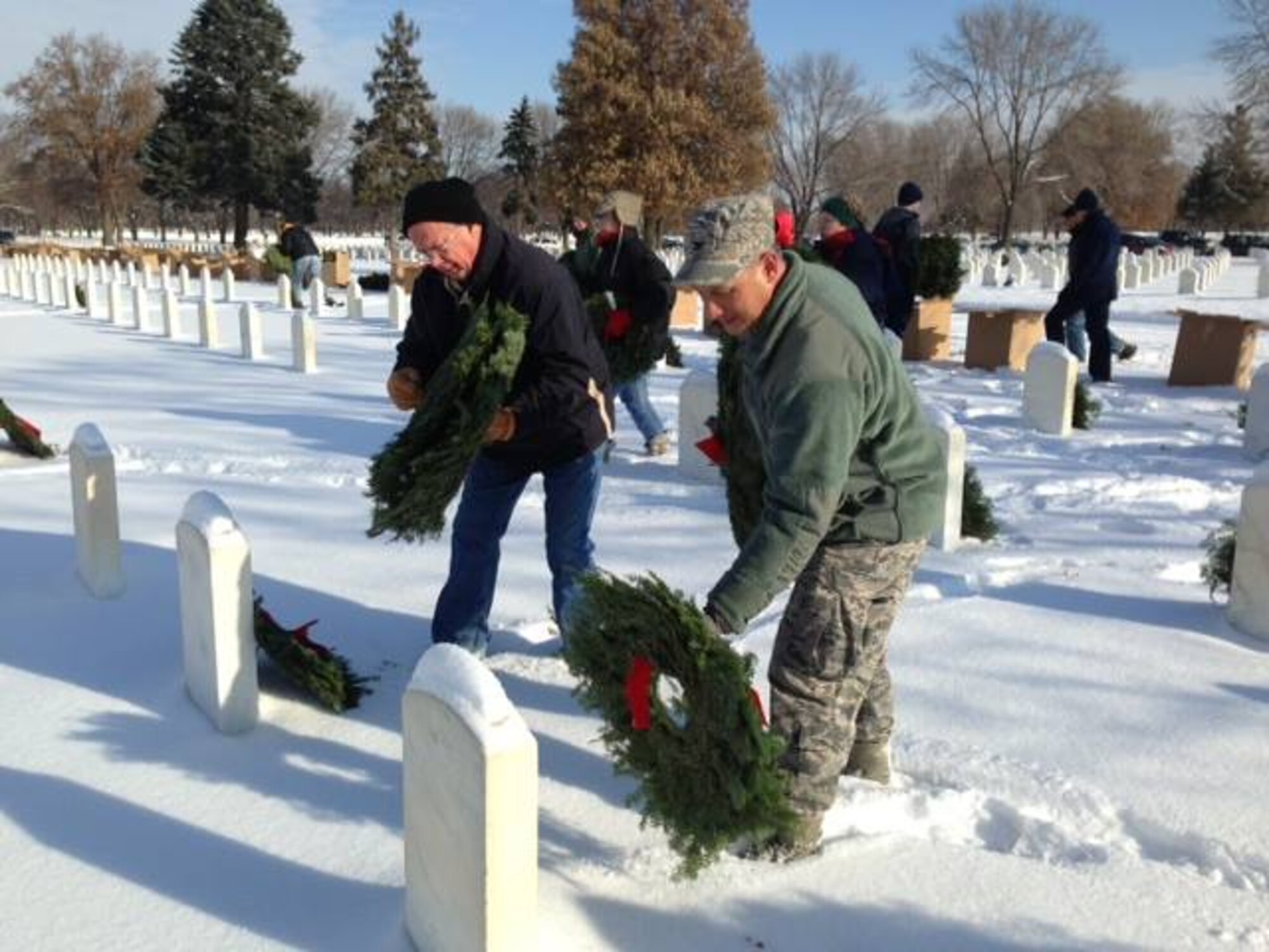 Col. Todd McCubbin, 934th Airlift Wing commander, places wreaths on the graves of the fallen Dec. 13 during the annual Wreaths Across America event at the Fort Snelling National Cemetery, Minn. (Air Force Photo/Maj. Sabra Brown)
