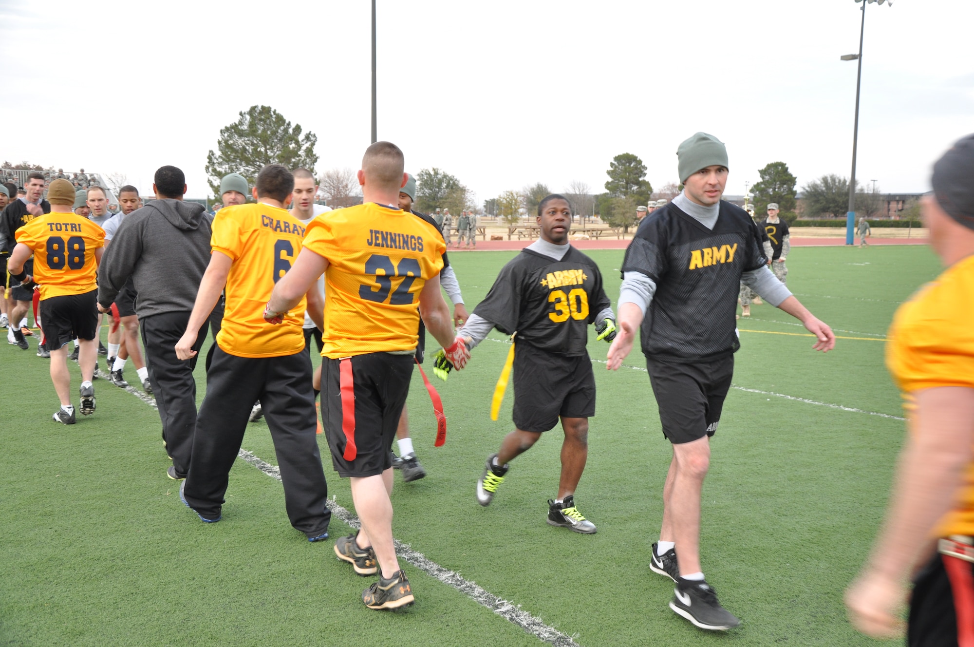 GOODFELLOW AIR FORCE BASE, Texas – The Army 344th Military Intelligence Battalion and Navy Center for Information Dominance Detachment flag football teams shake hands after the Army-Navy flag football game at the Mathis Fitness Center football field Dec. 11. The Army won the game 27 to 6 and the last nine out the ten previous flag football matches. (U.S. Air Force photo/ Senior Airman Joshua Edwards)