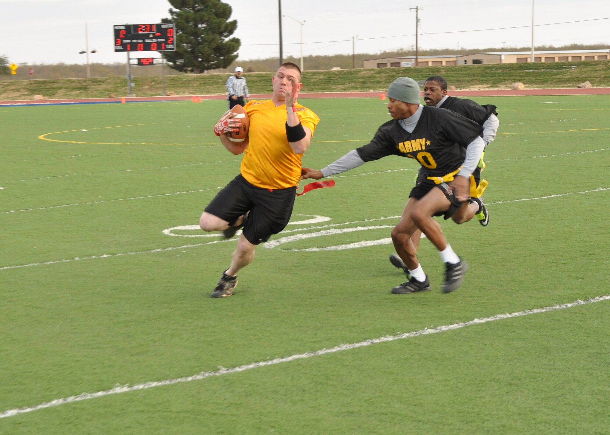 GOODFELLOW AIR FORCE BASE, Texas – Marine Tyler Jennings, Navy flag football receiver, avoids getting his flag pulled during the Army-Navy flag football game at the Mathis Fitness Center football field Dec. 11. Jennings gained several yards before running out of bounds. (U.S. Air Force photo/ Senior Airman Joshua Edwards)