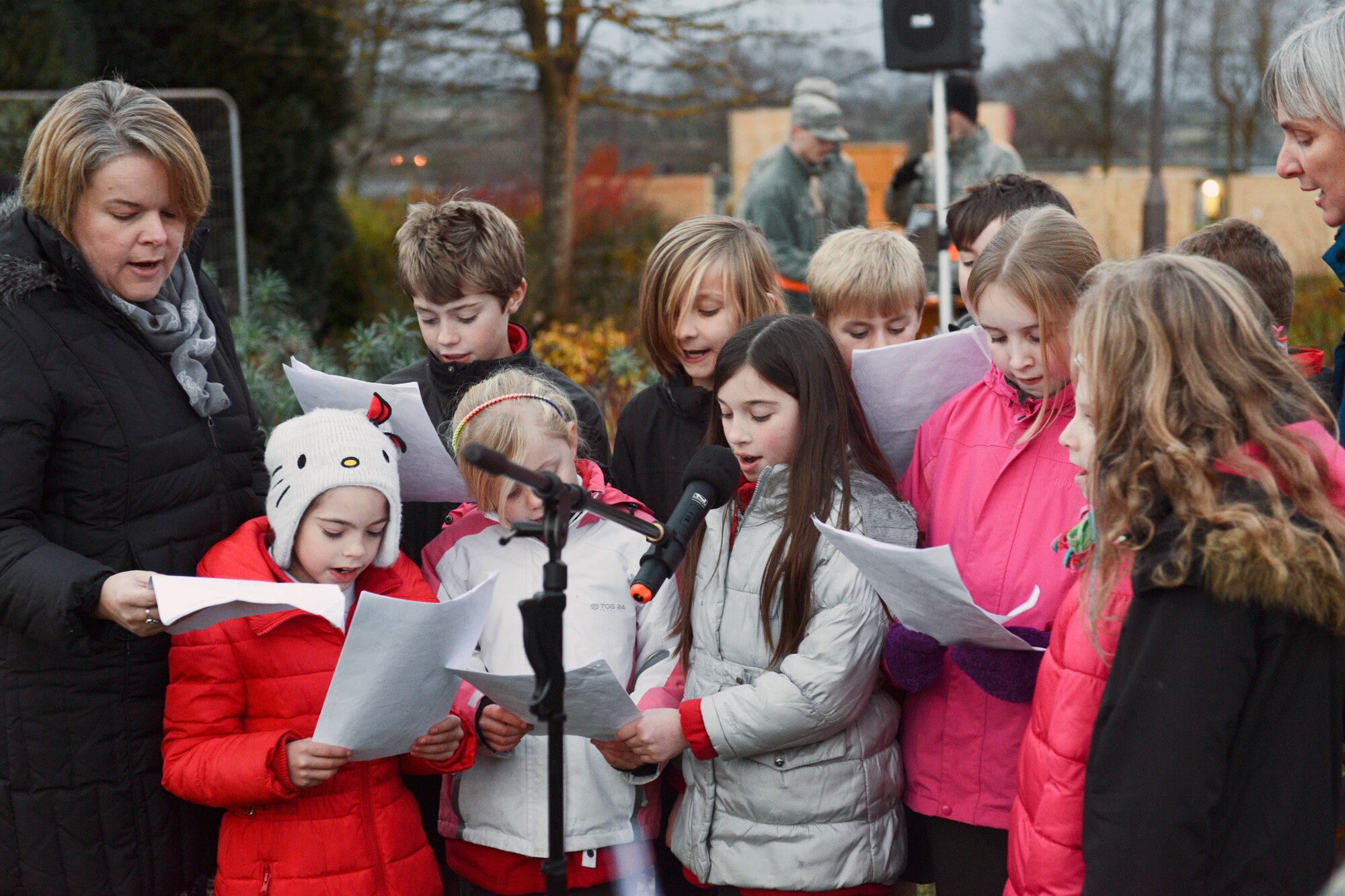 RAF CROUGHTON, United Kingdom – The Children’s Choir sings Christmas Carols during the RAF Croughton Tree Lighting Ceremony Dec. 6. The tree lighting was held in front of the RAF Croughton Chapel and included a visit from Santa. (U.S. Air Force photo by Tech. Sgt. Chrissy Best)