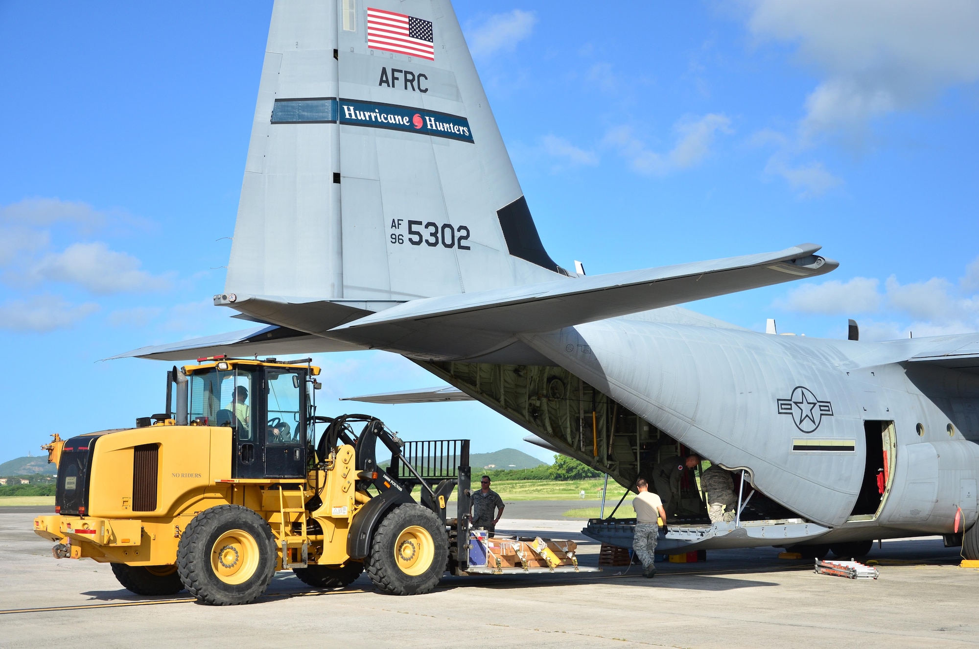 Reservists from the 403rd Wing, Keesler Air Force Base, Miss., unload a pallet off a WC-130J at Henry E. Rohlsen Airport, St. Croix, U.S. Virgin Islands, Dec. 12, 2013 during Roll Up. This mission officially closes the 2013 Atlantic hurricane hunting operations for the 53rd Weather Reconnaissance Squadron. (U.S. Air Force photo/Master Sgt. Brian J. Lamar)