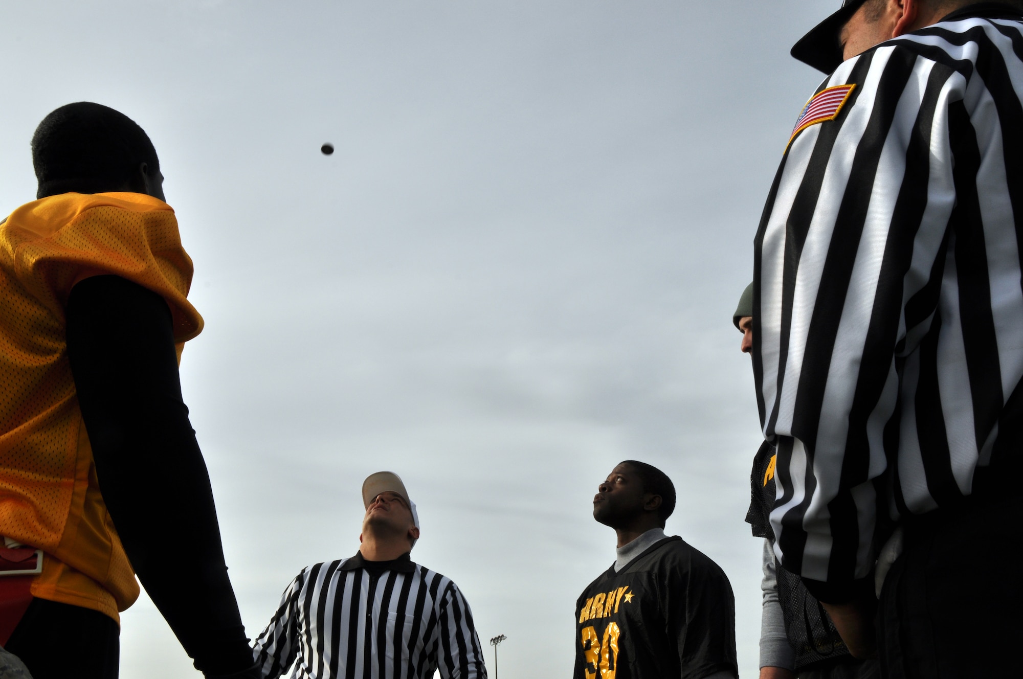 GOODFELLOW AIR FORCE BASE, Texas – The Army 344th Military Intelligence Battalion and Navy Center for Information Dominance Detachment flag football teams’ captains meet for the coin toss at the Army-Navy flag football game at the Mathis Fitness Center football field Dec. 11. The Navy won the toss and chose to receive the ball. (U.S. Air Force photo/ Senior Airman Joshua Edwards)