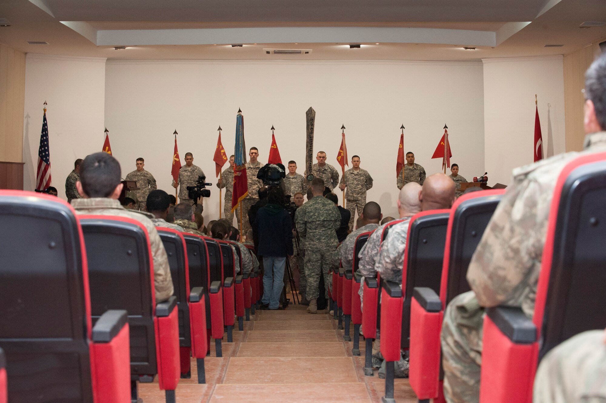 Representatives from multiple Turkish media outlets gather photos and footage of a transfer of authority ceremony between the 3rd Battalion, 2nd Air Defense Artillery and the 5th Battalion, 7th Air Defense Artillery Dec. 13, 2013, at a Turkish army base theater in Gaziantep, Turkey, after. The 5-7 ADA took over the responsibility of providing PATRIOT missile air defense capabilities as part of a multinational NATO mission to protect Turkey from Syrian ballistic missile threats. The 3-2 ADA, based at Fort Sill, Okla., spent nearly a year in Turkey after arriving at Incirlik Air Base, Turkey, in January 2013. The 5-7 ADA deployed from their home station at the Rhine Ordnance Barracks, Kaiserslautern, Germany. (U.S. Air Force photo by 1st Lt. David Liapis)