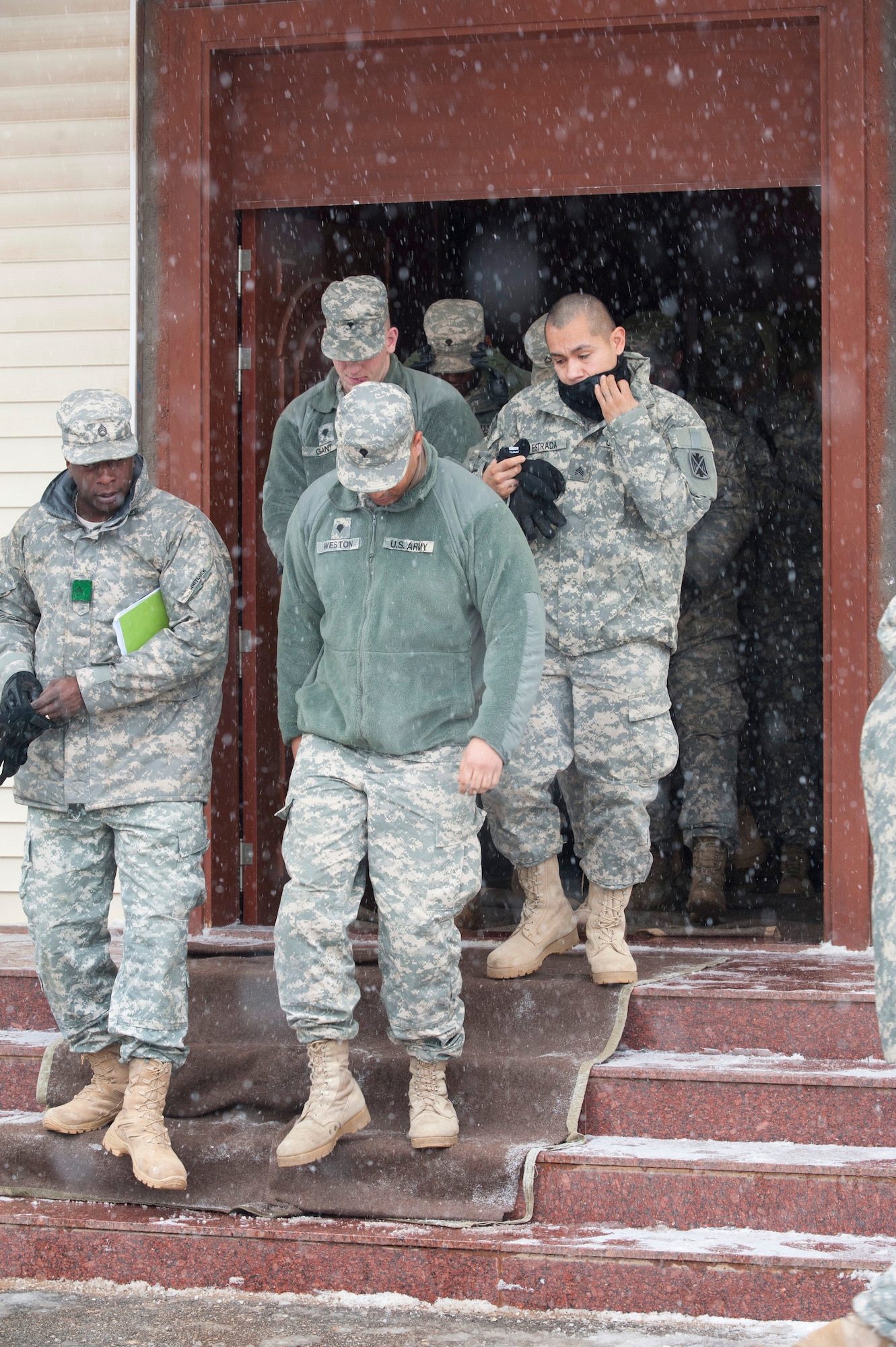 U.S. Army soldiers exit a theater at a Turkish army base in Gaziantep, Turkey, after a transfer of authority ceremony between the 3rd Battalion, 2nd Air Defense Artillery and the 5th Battalion, 7th Air Defense Artillery Dec. 13, 2013. The 5-7 ADA took over the responsibility of providing PATRIOT missile air defense capabilities as part of a multinational NATO mission to protect Turkey from Syrian ballistic missile threats. The 3-2 ADA spent nearly a year in Turkey after arriving at Incirlik Air Base, Turkey, in January 2013. The 5-7 ADA deployed from their home station at the Rhine Ordnance Barracks, Kaiserslautern, Germany. (U.S. Air Force photo by 1st Lt. David Liapis)