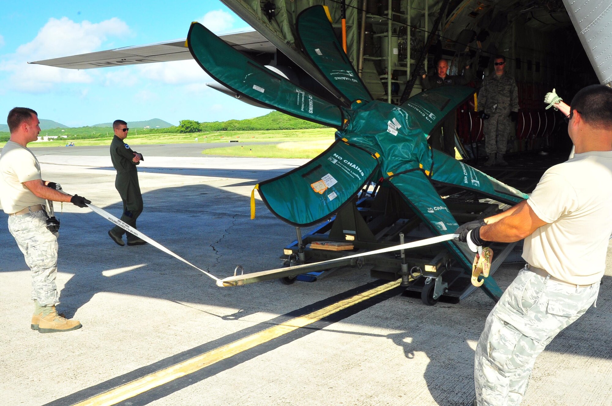 Reservists from the 403rd Wing load a propeller onto a WC-130J at Henry E. Rohlsen Airport, St. Croix, U.S. Virgin Islands, Dec. 12, 2013.  Aircrews from the 53rd Weather Reconnaissance Squadron, known as the Hurricane Hunters, forward deploy to St. Croix to fly storms on the Atlantic side during hurricane season. The squadron sets up test equipment, toolboxes, aircraft parts and satellite communications equipment in May and then returns it to Keesler Air Force Base, Miss., in December each year. (U.S. Air Force photo/Maj. Marnee A.C. Losurdo)