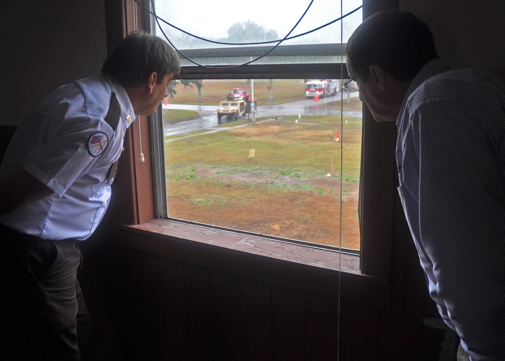 Two employers watch as a 919th Special Operations Security Forces Squadron humvee approaches during a simulated hostage rescue scenario at Duke Field, Fla. Dec. 9.   The scenario was part of the 919th Special Operations Wing's annual Employer Appreciation Day, an event held to educate civilian employers of Duke Field reservists on the wing's wartime mission and to thank them for their support. (U.S. Air Force photo/Dan Neely)
