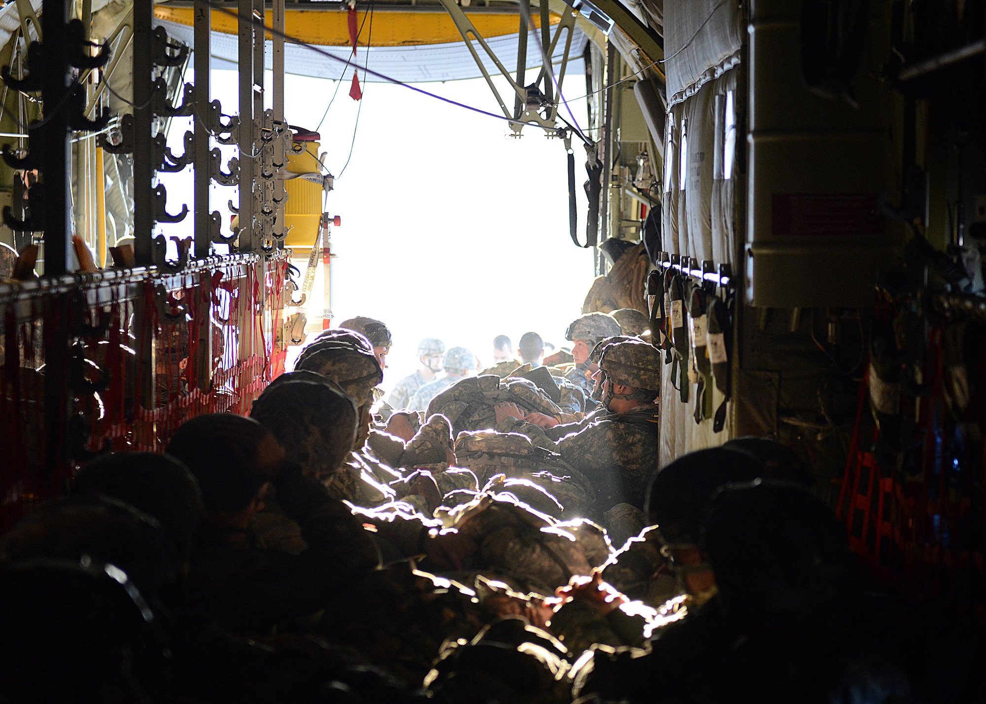 Paratroopers from the 1st Batallion, 503rd Infantry Regiment, 173rd Airborne Brigade Combat Team, prepare for takeoff in the back of a C-130 Hercules, Dec. 11, 2013, at Aviano Air Base, Italy.  Airmen from Ramstein Air Base, Germany, partnered with soldiers from U.S. Army at Vicenza to conduct airfield seizure training operations on Rivolta Italian air force base. (U.S. Air Force photo/Airman Ryan Conroy)