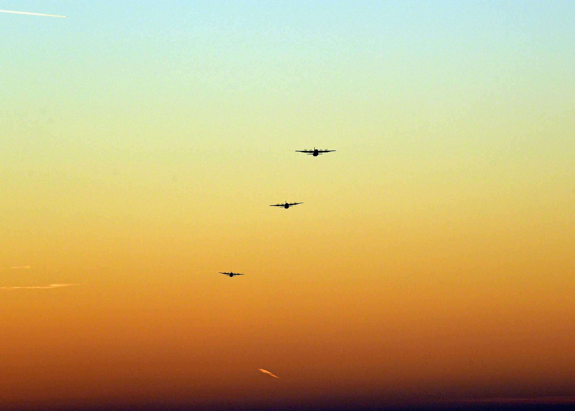 Three C-130 Hercules prepare to drop  more than 50 paratroopers from 1st Batallion, 503rd Infantry Regiment and the 173rd Airborne Brigade Combat Team, Dec.11, 2013, at Rivolta Italian air force base, Italy. The soldiers from U.S. Army at Vicenza conducted airfield seizure training operations as part of the two week close air support training exercise with pilots from Aviano Air Base, Italy. (U.S. Air Force photo/Senior Airman Briana Jones)