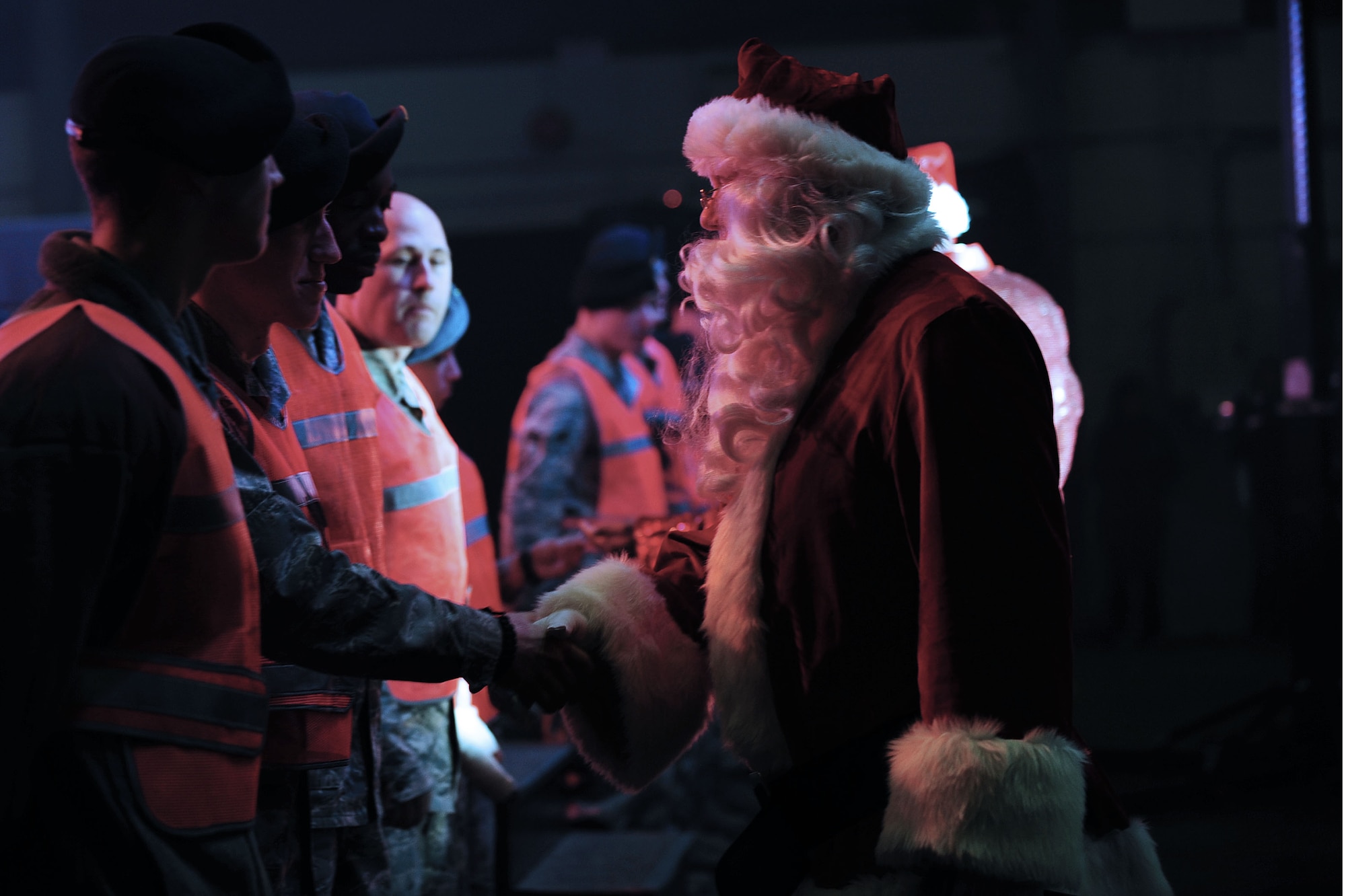 Santa Clause shakes the hand of a 39th Security Forces Squadron Airmen to thank him and all of the 39th SFS Airmen who were on duty during a Tops in Blue performance Dec. 14, 2013, at Incirlik Air Base, Turkey.  During their visit at Incirlik AB, Tops in Blue donated multiple gifts to the community center from the single Airmen's fund, and gave gifts to security forces Airmen who participated in a raffle after the show. (U.S. Air Force photo by Airmen 1st Class Nicole Sikorski/Released) 