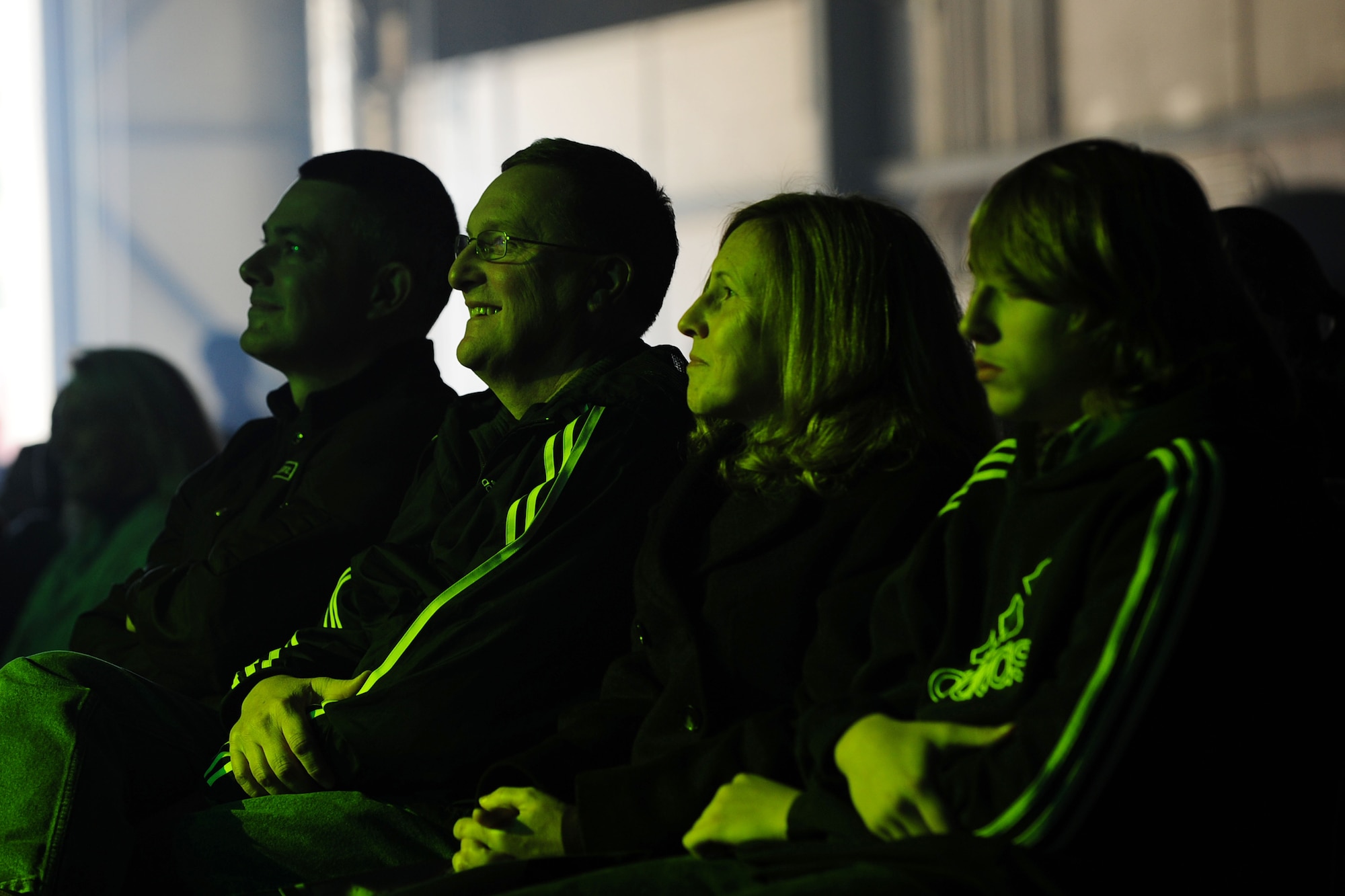 Smiling service members and families watch a performance by Tops in Blue Dec. 14, 2013, at Incirlik Air Base, Turkey. The group of traveling performers consists of 28 Airmen comprised of vocalists, dancers, musicians and technicians who perform for deployed service members and coalition forces around the world. (U.S. Air Force photo by Airman 1st Class Nicole Sikorski/Released) 