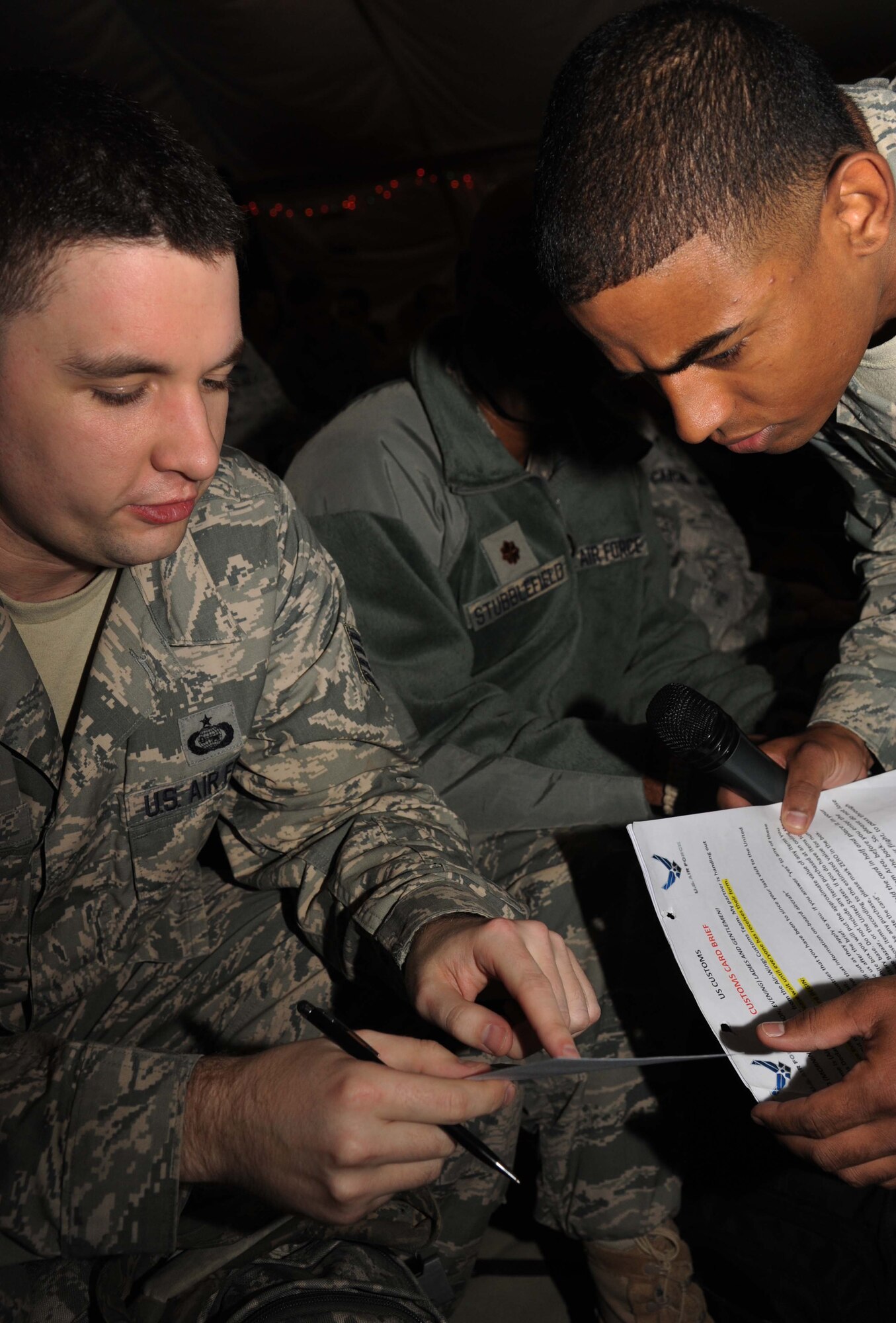 Staff Sgt. Edwin Jacob, 386th Expeditionary Logistics Readiness Squadron,
assists Staff Sgt. Daniel Poe, 386th Air Expeditionary Group, with his
customs form prior to his departure, undisclosed location, Southeast Asia.
Jacobs is a part of a team working on behalf of the United States Customs
and Border Patrol and the United States Department of Agriculture to ensure
no contraband or agricultural hazards find their way from the AOR into the
United States. (U.S. Air Force photo by Senior Airman Desiree W. Moye)
