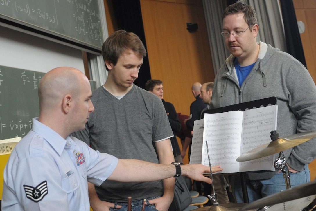 Thhe USAFE Band Ambassadors Jazz Ensemble conduct a masterclass for students of the Kaiserslautern University Big Band.  SSgt Jon Friedman works with percussion students on interpreting drum charts.