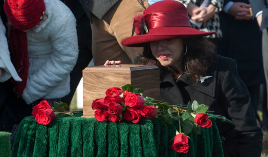 Ginger Gilbert Ravella kneels next to her late husband???s Maj Troy Gilbert, remains, during his remembrance funeral at Arlington Cemetery, Dec. 11, 2013. (U.S. Air Force photo by Staff Sgt. Carlin Leslie)