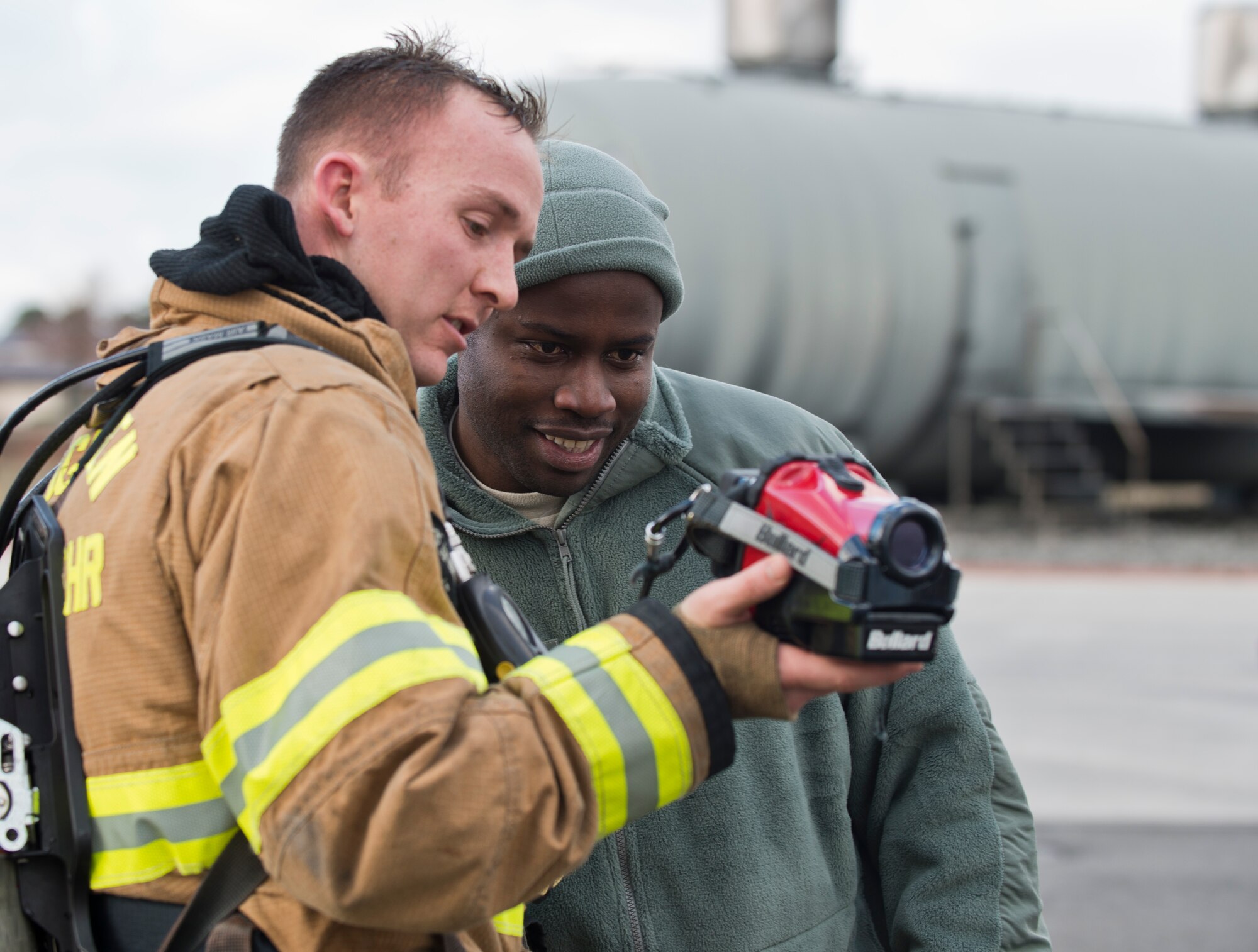 Staff Sgt. David Lund, 86th Civil Engineer Squadron firefighter, shows Staff Sgt. Rudolph Richards, 86th Airlift Wing chaplain assistant, a thermal imaging camera, Dec. 6, 2013, Ramstein Air Base, Germany. Richards spent the majority of his day talking with Airmen from various units to learn about their career and raise morale. (U.S. Air Force photo/Senior Airman Jonathan Stefanko)