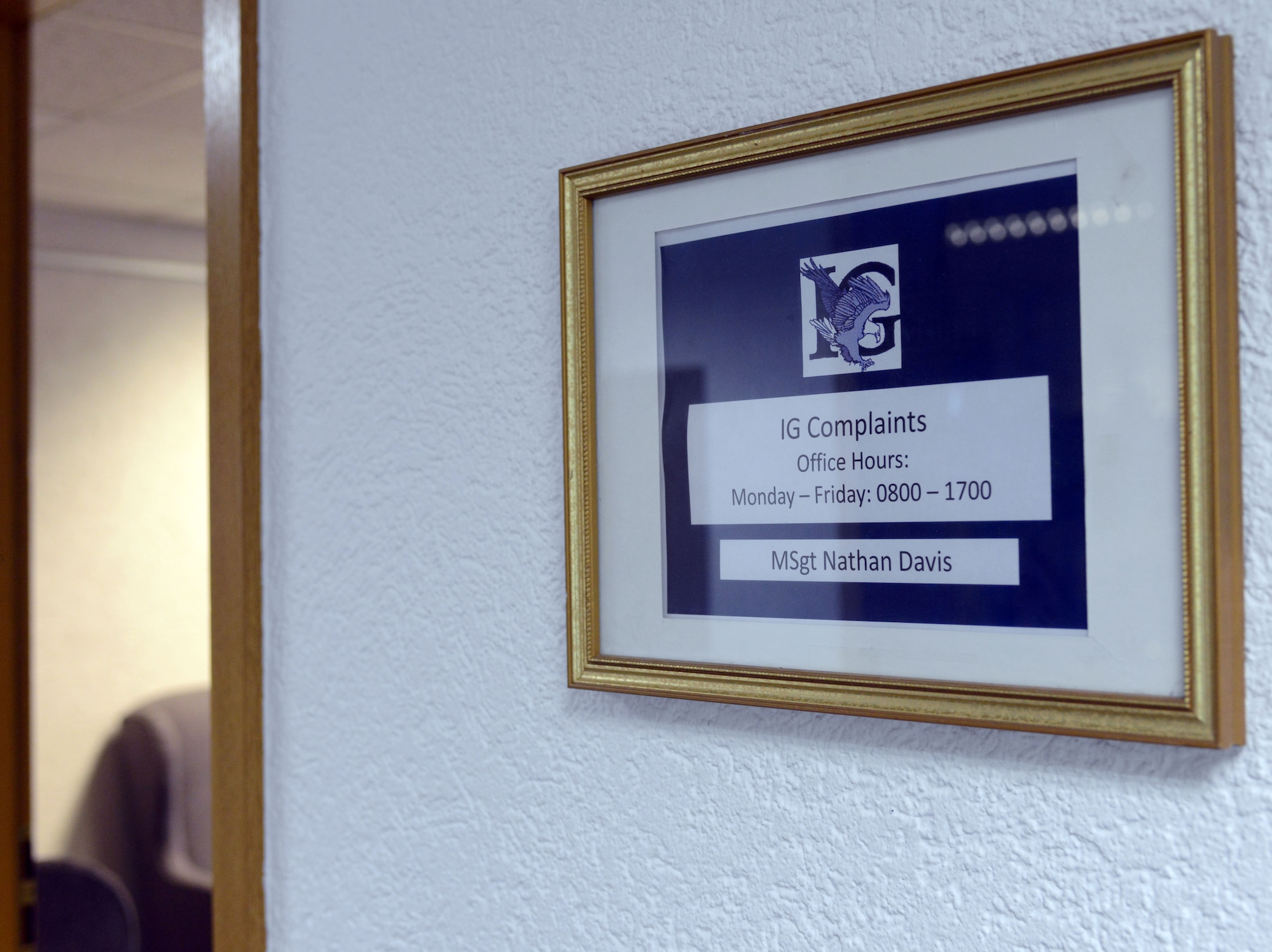A sign hangs outside the 86th Airlift Wing Inspector General complaints section, Dec. 13, 2013, Ramstein Air Base, Germany. The sign displays the office hours of the complaints section. Anyone is allowed to visit the IG to make a complaint, but they can also contact the IG by email or phone. (U.S. Air Force photo/Senior Airman Timothy Moore)