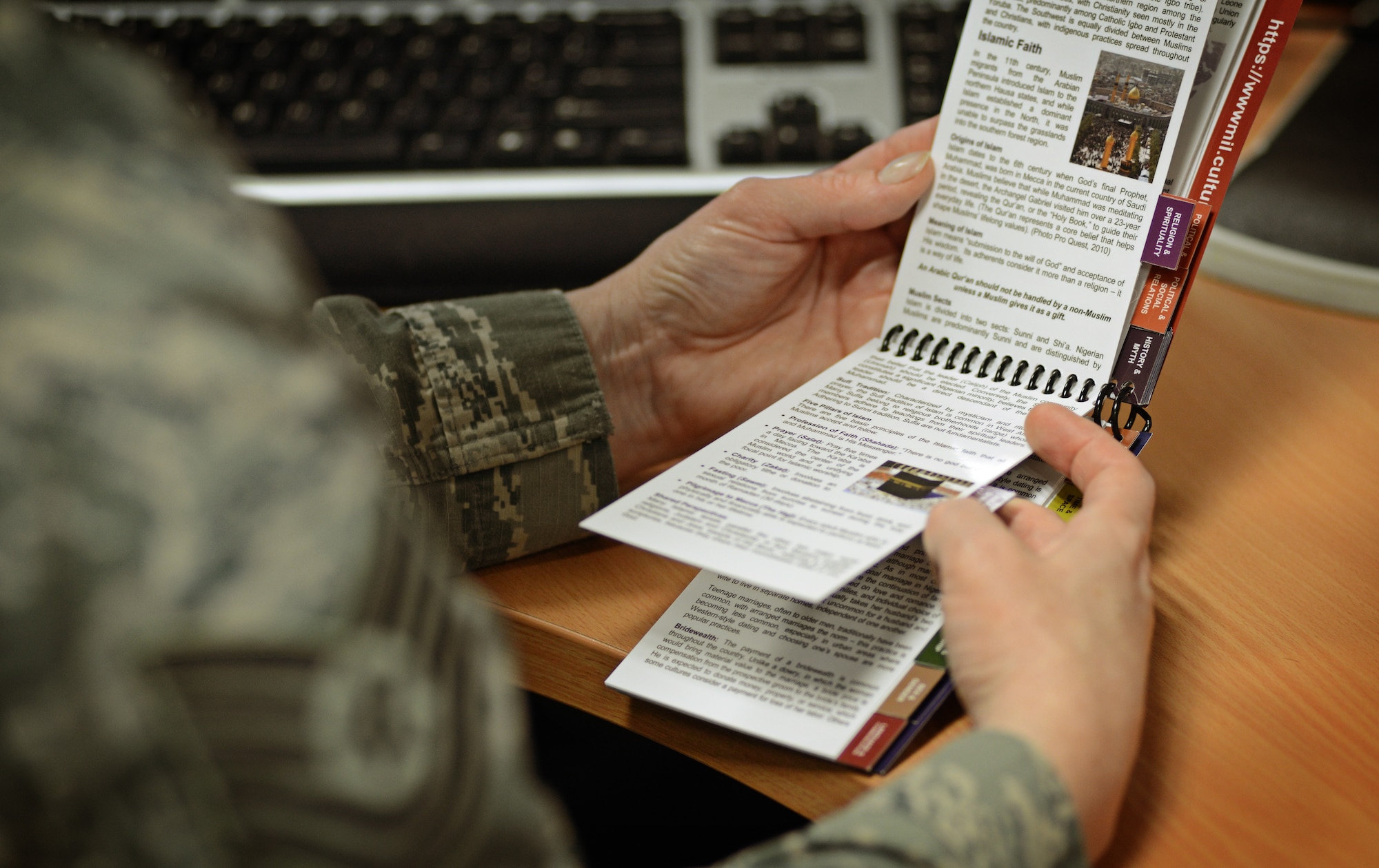 An Airman reviews a culture guide for Nigeria produced by the Air Force Culture and Language Center Dec. 16, 2013. The culture guides were created to better prepare servicemembers traveling to new areas of the world where cultures may be vastly different than their own. The culture guides are a quick reference aide that fit into your pocket and improve mission effectiveness by ensuring an understanding of cultural differences. (U.S. Air Force photo/ Staff Sgt. Ryan Crane)