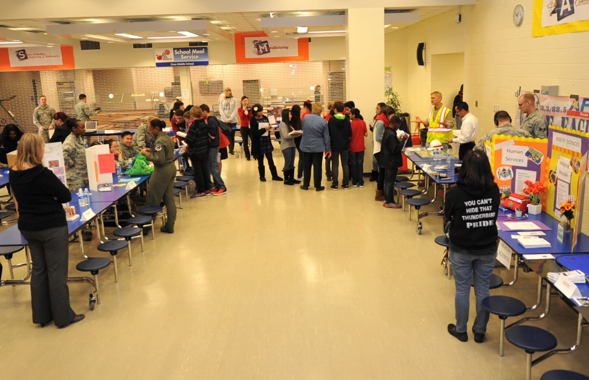 Osan Middle School students enter the school’s first ever career fair at Osan Air Base, Republic of Korea, Dec. 13, 2013. The event was the culmination of a week spent learning about different career opportunities in both the military and civilian sectors. (U.S. Air Force photo/Airman 1st Class Ashley J. Thum)