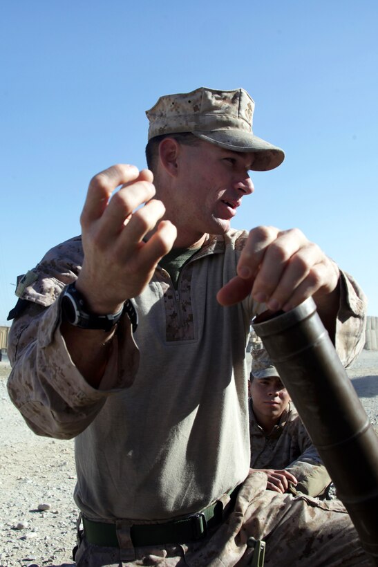 U.S. Marine Corps Lance Cpl. Zach Swart demonstrates loading an M224A1 60mm mortar system on Forward Operating Base Sabit Qadam in Helmand province, Afghanistan, Dec. 8, 2013. Swart, a mortarman, is assigned to Weapons Company, 3rd Battalion, 7th Marine Regiment.