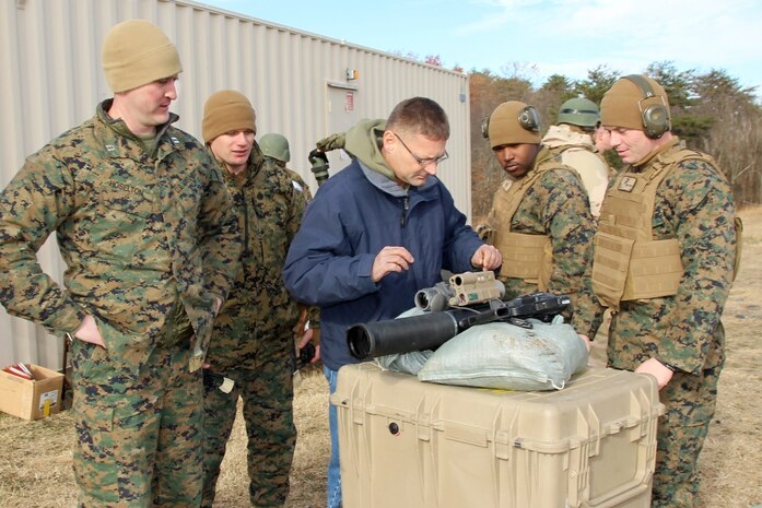 (From left) Capt. Trevor Hoselton, Staff Sgt. Ken Thorson and Les Inbody with Marine Corps Systems Command’s Shoulder-launched Multipurpose Assault Weapon Project Office, look over a SMAW Mod 2 with a new modular ballistic sight at Marine Corps Base Quantico, Va., in late November. The other Marines, attached to The Basic School, participated in an operational assessment with the SMAW team and members of the Marine Corps Operational Test and Evaluation Activity. 