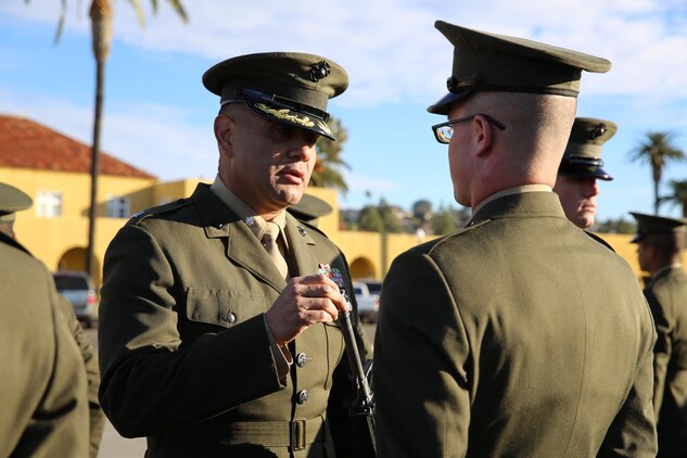 Lt. Col. Tomas Carlos, commanding officer, 3rd Recruit Training Battalion, inspects a rifle for cleanliness during the Battalion Commander’s Inspection aboard the depot, Dec. 10.  The purpose of the inspection was for the battalion commander to ensure the newly forged Marines have been properly trained and meet the basic requirement to continue on with their training.
