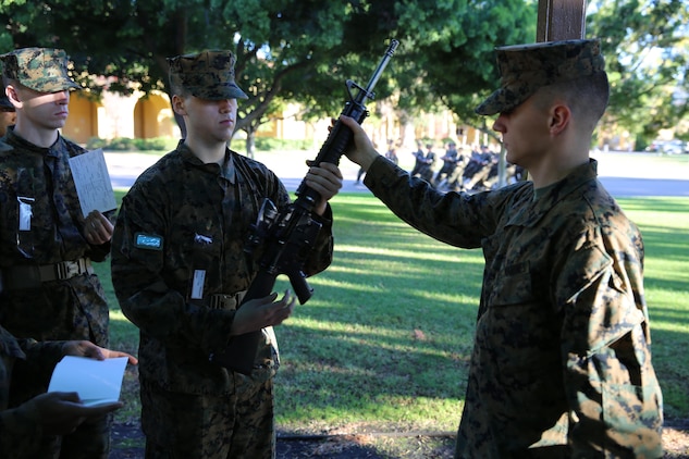 Lance Cpl. Brendon M. Walsh, armorer, Headquarters Company, Headquarters and Service Battalion, hands an M16-A4 service rifle to Recruit Johnathan Flores, Platoon 3255, Company L, 3rd Recruit Training Battalion, during their rifle issue aboard Marine Corps Recruit Depot San Diego, Nov. 25.  The purpose of receiving the rifles was for recruits to learn and train with them in order to gain proficiency as a marksmen during recruit training.