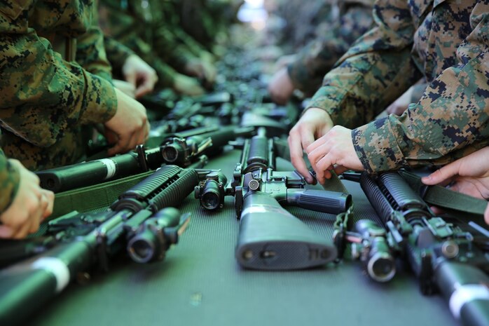 Recruits of Company L, 3rd Recruit Training Battalion, attach their parade sling to their newly issued weapons aboard Marine Corps Recruit Depot San Diego, Nov. 25.  The M16-A4 service rifle is routinely issued to recruits on training day one.