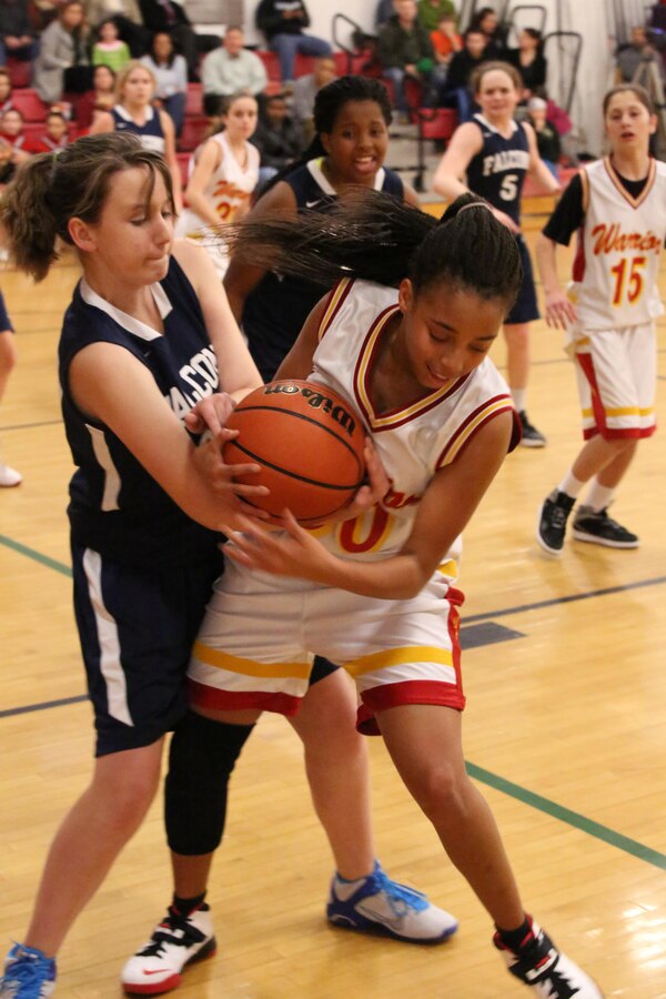 Alexus, forward, fights for the ball during a varsity basketball game against the Fredericksburg Academy Falcons on Dec. 11, 2013. The Falcons beat the Warriors 39-18. 