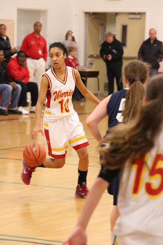 Marquis, guard, dribbles the ball while looking for a teammate during a varsity basketball game against the Fredericksburg Academy Falcons on Dec. 11, 2013. The Warriors lost the third game of the season 39-18. 