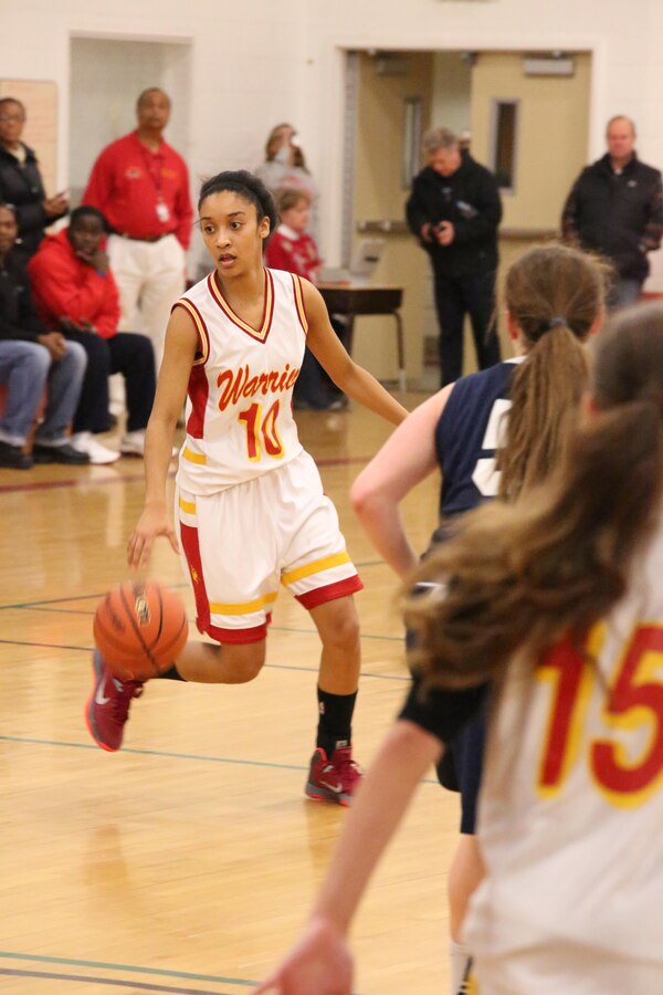 Marquis, guard, dribbles the ball while looking for a teammate during a varsity basketball game against the Fredericksburg Academy Falcons on Dec. 11, 2013. The Warriors lost the third game of the season 39-18. 