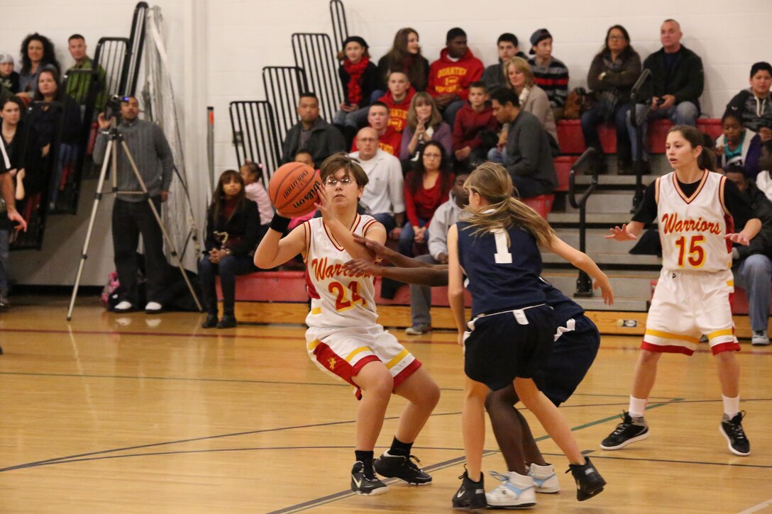 Meghan, guard, passes the ball to a teammate during a varsity basketball game against the Fredericksburg Academy Falcons on Dec. 11, 2013. The Falcons triumphed 39-18.