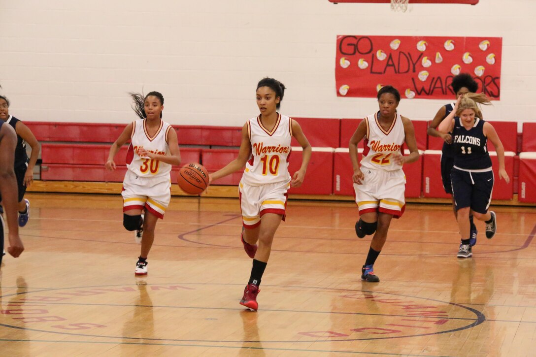Marquis, a guard, dribbles a ball during a game against the Fredericksburg Academy Falcons at the Quantico Middle/High School on Dec. 11, 2013. The Warriors lost 39-18.  