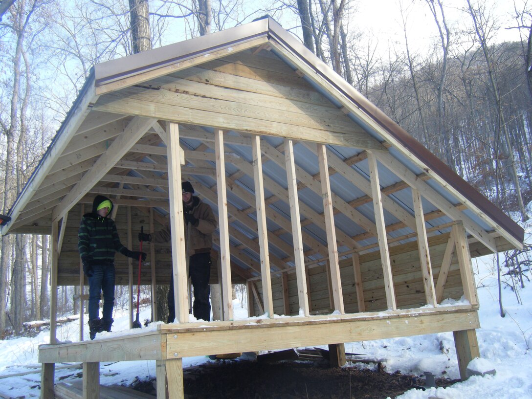 Eagle Scout volunteer Nick Whitmore puts the finishing touches on an adirondack shelter he constructed for the Terrace Mountain Trail.