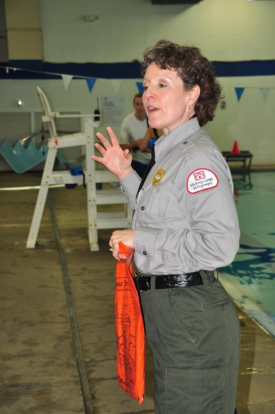 U.S. Army Corps of Engineers Park Ranger Sondra Carmen instructs youth on procedures to secure a life jackets and the importance of water safety as part of the Learn to Swim Program at the Putnam County Family YMCA in Cookeville, Tenn. (photo by Mark Rankin) 