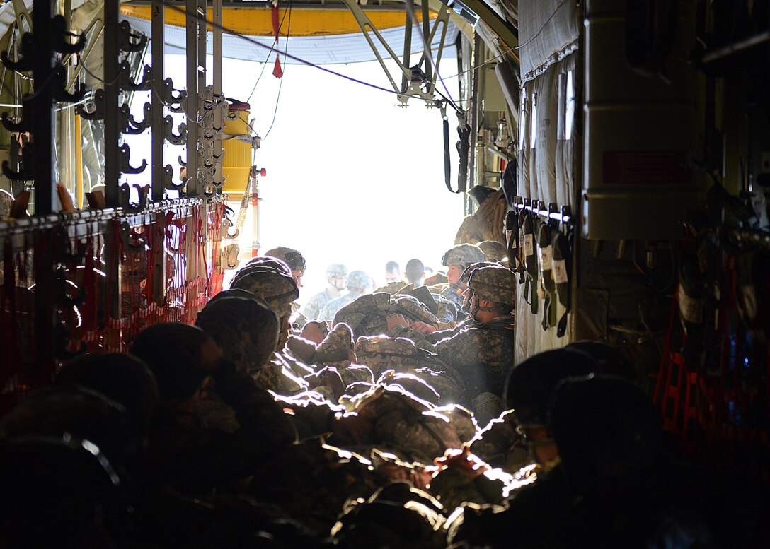 Paratroopers from the 1st Batallion, 503rd Infantry Regiment, 173rd Airborne Brigade Combat Team, prepare for takeoff in the back of a C-130 Hercules, Dec. 11, 2013, at Aviano Air Base, Italy. Airmen from Ramstein Air Base, Germany, partnered with soldiers from U.S. Army at Vicenza to conduct airfield seizure training operations on Rivolta Italian air force base.