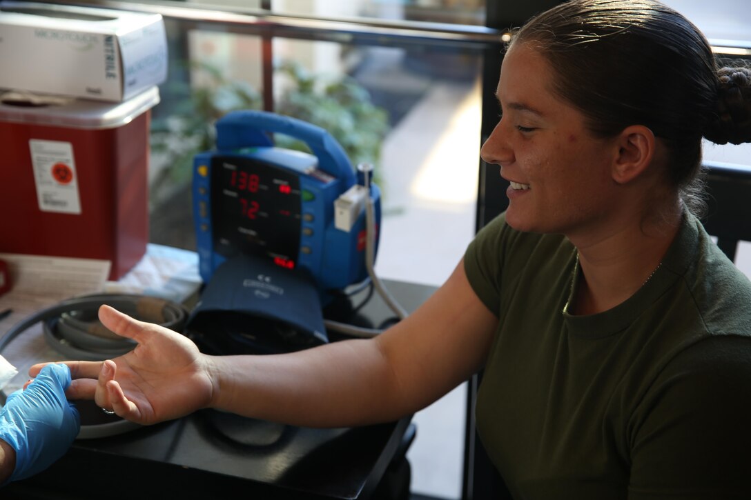 Lance Cpl. Brittany Coventry, an administration specialist stationed aboard Marine Corps Air Station Miramar, gets her iron levels checked before donating blood for Navy Medical Center San Diego, Dec. 17. NMCSD received blood and bone marrow donations for service members that need it most. 