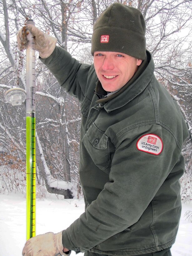 Corps park ranger Scott Tichy faces bitter temperatures in Valley City, N.D., to take frost measurements from the frost tube guage at Baldhill Dam. (The frost tube reading here was 14 inches.) The rangers at this site take weekly frost depth, lake ice thickness, snow depth and snow water equivalent readings. This information is then used by Corps water management officials and the National Weather Service to help with forecasting and determine the winter drawdown level for Lake Ashtabula. Photo by Rich Schueneman, USACE