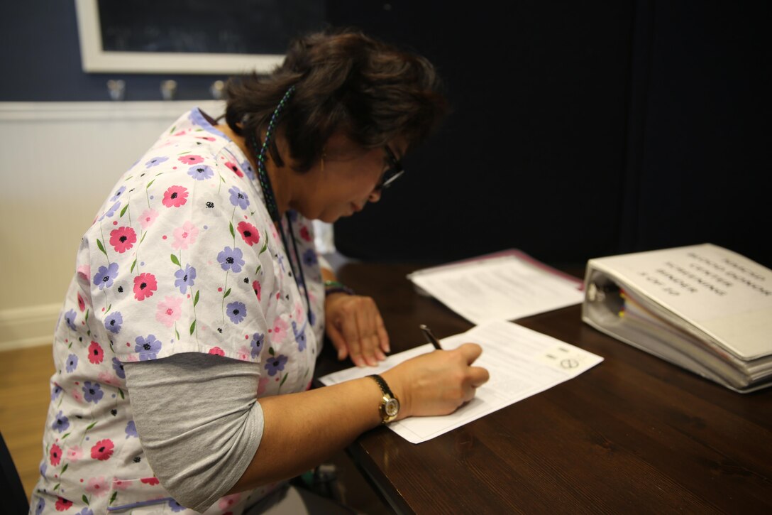 Marialuz Roberto, a phlebotomist with the Naval Medical Center San Diego, performs personal interviews with potential blood donors aboard Marine Corps Air Station Miramar, Calif., Dec. 17. Blood donors needed to go through certain steps, such as filling out paper work and getting their iron levels checked, in order to be eligible to donate. 