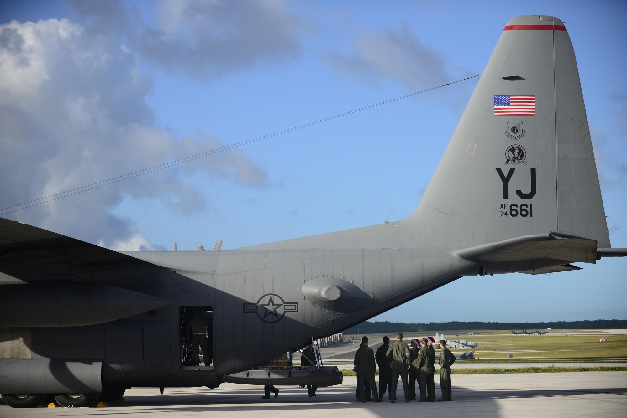 A C-130 Hercules crew from the 36th Airlift Squadron prepares for an airdrop mission during Operation Christmas Drop at Andersen Air Force Base, Guam, Dec. 11, 2013. This year marks the 62nd year of Operation Christmas Drop, which began in 1952, making it the world's longest running airdrop mission. Every December, C-130 Hercules crews from the 374th Airlift Wing at Yokota Air Base, Japan, partner with the 36th Wing at Andersen Air Force Base, Guam, to airlift food, supplies and toys to islanders throughout Micronesia. (U.S. Air Force photo/2nd Lt. Jake Bailey) 

