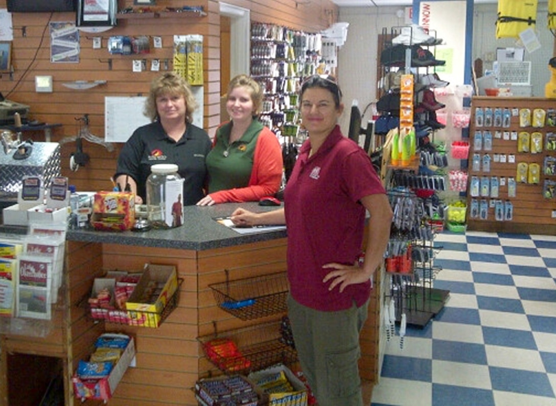 Biologist Nicole Liette (right) visits the bait and tackle store at Roland Martin’s Marina as part of the regular face-to-face outreach the Corps does every few weeks around the lake. 