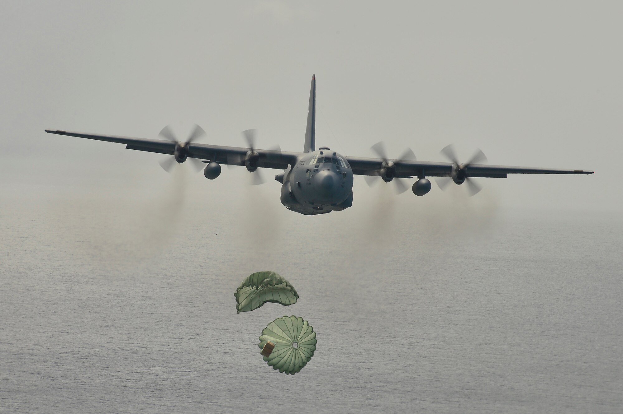 A C-130 Hercules airdrops supplies to Micronesian islanders during Operation Christmas Drop near Andersen Air Force Base, Guam, Dec. 16, 2013. This year marks the 62nd year of Operation Christmas Drop, which began in 1952, making it the world's longest running airdrop mission. Every December, C-130 Hercules crews from the 374th Airlift Wing at Yokota Air Base, Japan, partner with the 36th Wing at Andersen Air Force Base, Guam, to airlift food, supplies and toys to islanders throughout Micronesia. (U.S. Air Force photo by 2nd Lt. Jake Bailey/Released)